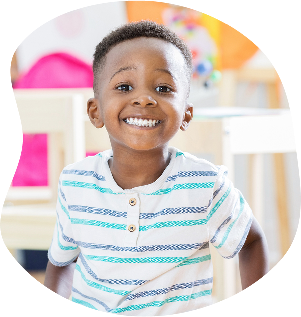 Young child smiling in preschool setting