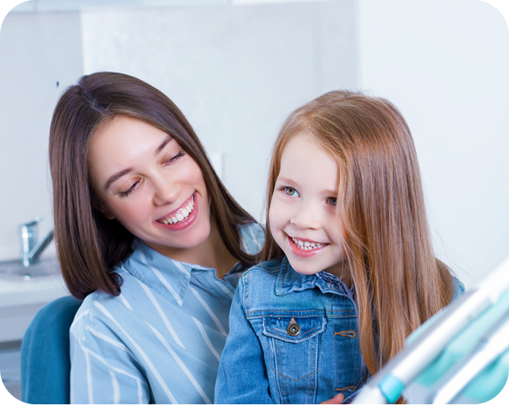 Smiling child sitting in their mothers lap
