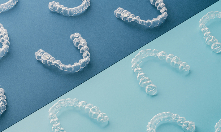 Close Up View Of Clear Aligners On Blue Background