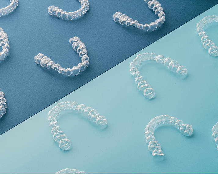 Close Up View Of Clear Aligners On Blue Background