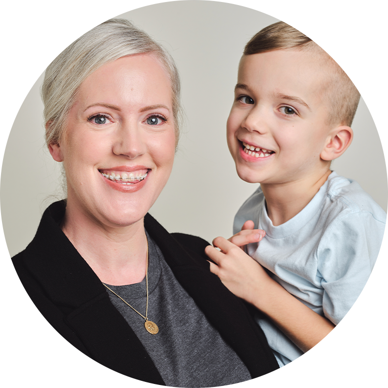 Smiling Mother Wearing Braces With Young Child