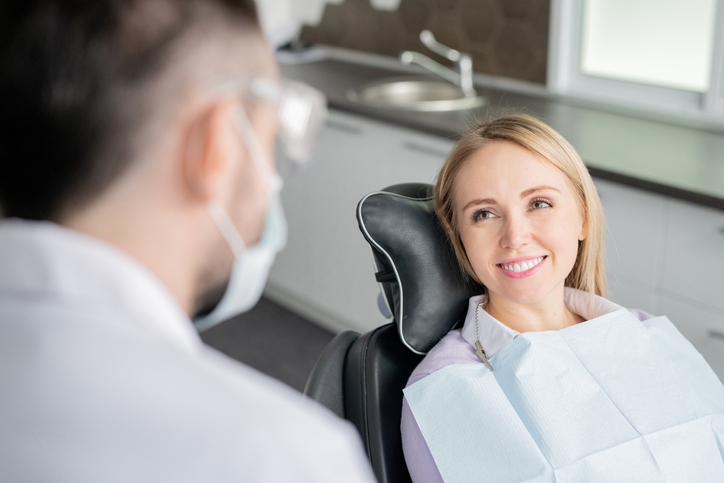 Smiling Woman In Orthodontist Chair