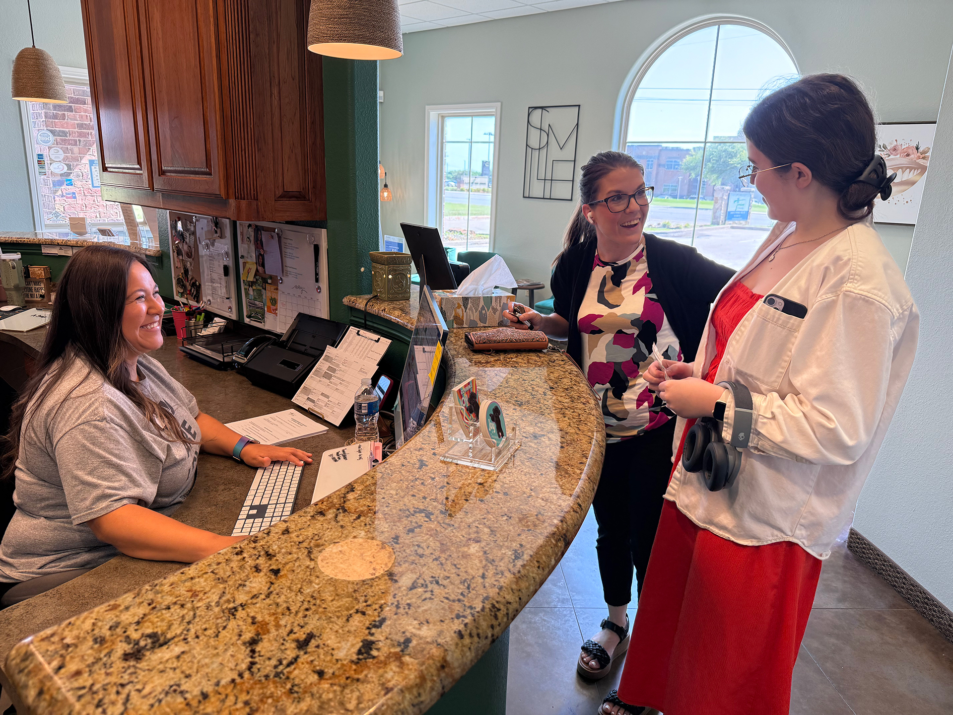 Tennison Orthodontics Front Desk With Smiling Staff Members And Patients