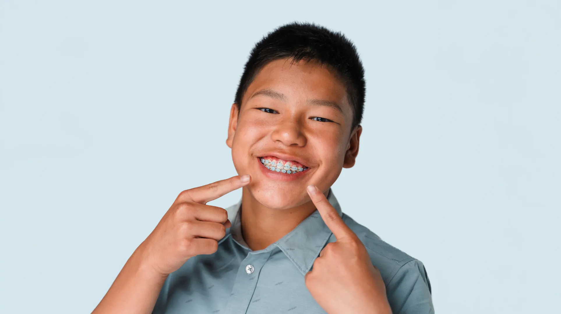 Teen boy points to his blue ties on his light force prices